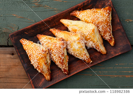 Homemade triangle puff pastry with meat on rustic background . Samosa Homemade triangle puff pastry with meat on rustic background . Samosa 118982386