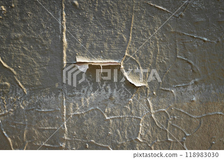 Detailed texture of aged plaster on an old wall revealing layers of history and unique patterns in natural light Detailed texture of aged plaster on an old wall revealing layers of history and unique patterns in natural light 118983030