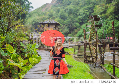 A female tourist dressed in the traditional dress of the inhabitants of the Vietnamese mountains, the Hmong. Woman in Sapa in the fog, Northwest Vietnam. Vietnam travel concept. UNESCO heritage A female tourist dressed in the traditional dress of the inhabitants of the Vietnamese mountains, the Hmong. Woman in Sapa in the fog, Northwest Vietnam. Vietnam travel concept. UNESCO heritage 118983210