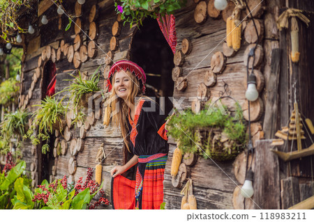 A female tourist dressed in the traditional dress of the inhabitants of the Vietnamese mountains, the Hmong. Woman in Sapa in the fog, Northwest Vietnam. Vietnam travel concept. UNESCO heritage A female tourist dressed in the traditional dress of the inhabitants of the Vietnamese mountains, the Hmong. Woman in Sapa in the fog, Northwest Vietnam. Vietnam travel concept. UNESCO heritage 118983211