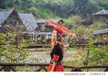A female tourist dressed in the traditional dress of the inhabitants of the Vietnamese mountains, the Hmong. Woman in Sapa in the fog, Northwest Vietnam. Vietnam travel concept. UNESCO heritage A female tourist dressed in the traditional dress of the inhabitants of the Vietnamese mountains, the Hmong. Woman in Sapa in the fog, Northwest Vietnam. Vietnam travel concept. UNESCO heritage 118983213