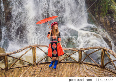 A female tourist dressed in the traditional dress of the inhabitants of the Vietnamese mountains, the Hmong. Woman in Sapa in the fog, Northwest Vietnam. Vietnam travel concept. UNESCO heritage A female tourist dressed in the traditional dress of the inhabitants of the Vietnamese mountains, the Hmong. Woman in Sapa in the fog, Northwest Vietnam. Vietnam travel concept. UNESCO heritage 118983222