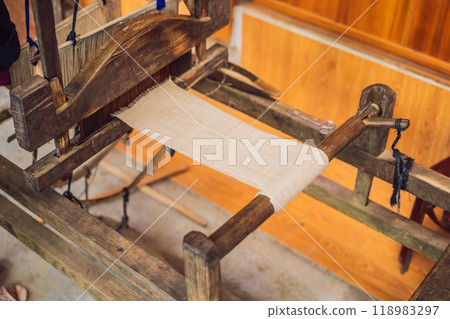 Village women busy weaving silk saree on handloom Village women busy weaving silk saree on handloom 118983297