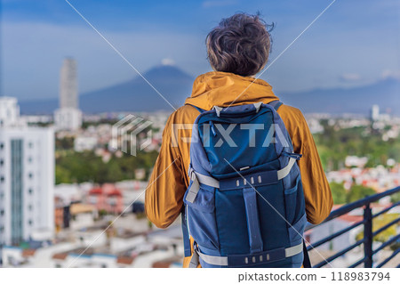 Male tourist in front of Popocatepetl Volcano, Mexico. Adventure, natural exploration, and travel experience concept Male tourist in front of Popocatepetl Volcano, Mexico. Adventure, natural exploration, and travel experience concept 118983794