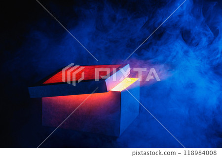 Man opens magic box with surprise on dark background, mystical box, surprise, halloween, monster box 118984008
