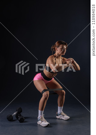 sporty girl doing exercises with dumbbells on black background, sport concept, healthy and beautiful body sporty girl doing exercises with dumbbells on black background, sport concept, healthy and beautiful body 118984018