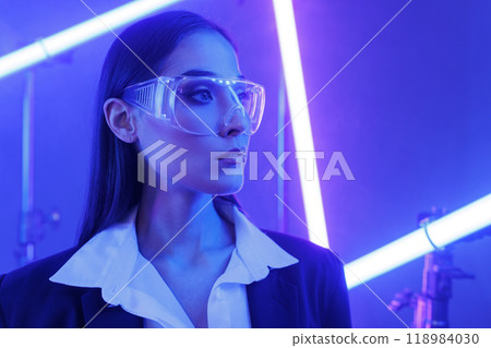 Concept of futuristic virtual reality technology or entertainment system. A woman lit up on the HUD interface 118984030