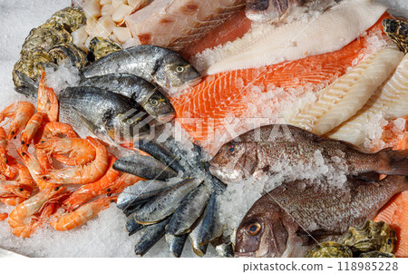 An enticing Fresh Seafood Display, beautifully arranged on ice and showcasing a variety of fish An enticing Fresh Seafood Display, beautifully arranged on ice and showcasing a variety of fish 118985228