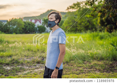 Runner wearing medical mask, Coronavirus pandemic Covid-19. Sport, Active life in quarantine surgical sterilizing face mask protection. Outdoor run on athletics track in Corona Outbreak Runner wearing medical mask, Coronavirus pandemic Covid-19. Sport, Active life in quarantine surgical sterilizing face mask protection. Outdoor run on athletics track in Corona Outbreak 118985978