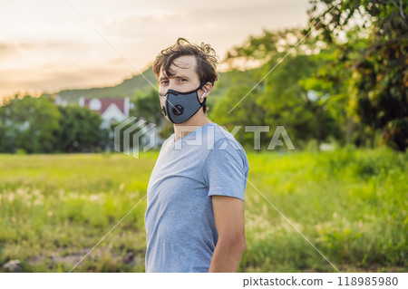 Runner wearing medical mask, Coronavirus pandemic Covid-19. Sport, Active life in quarantine surgical sterilizing face mask protection. Outdoor run on athletics track in Corona Outbreak 118985980