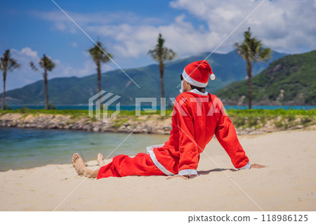 Santa Claus relaxing on sea beach - christmas or happy new year concept. Christmas in the tropics after quarantine was lifted Coronovirus COVID 19 concept Santa Claus relaxing on sea beach - christmas or happy new year concept. Christmas in the tropics after quarantine was lifted Coronovirus COVID 19 concept 118986125