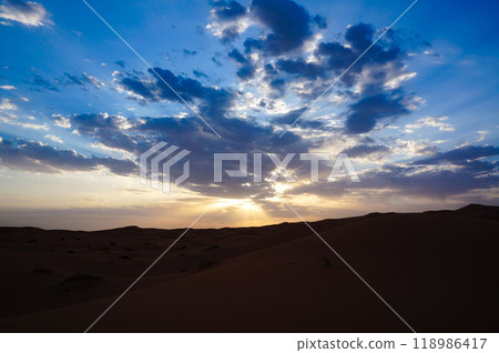 Divine sunlight illuminating the desert land as the sun sets 118986417