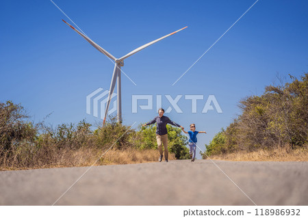 Alternative energy, wind farm and happy time with your family. Happy father on the road with his son on vacation and escape to nature. Father and son waving their arms like a windmill 118986932