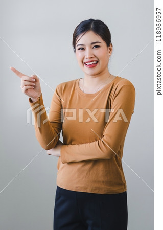 Confident asian woman with friendly smile stands with arms crossed isolated on white background. Confident asian woman with friendly smile stands with arms crossed isolated on white background. 118986957