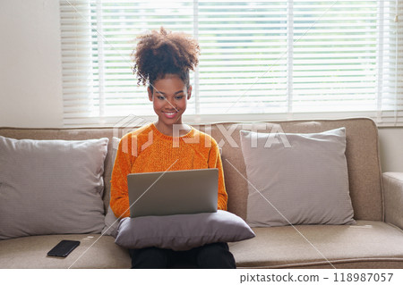 Relaxed Young African American Woman Working on Laptop at Home. Relaxed Young African American Woman Working on Laptop at Home. 118987057