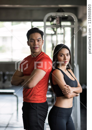 fit sporty Asian young male and female couple at fitness gym. 118988803