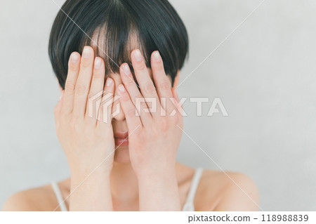 Woman covering her face with her hands Woman covering her face with her hands 118988839