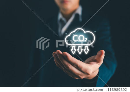 Reduce CO2 and Net zero emissions concept. Climate change to limit global warming and sustainable development and green business. CO2 reduction on businessman hand for save world carbon neutral. Reduce CO2 and Net zero emissions concept. Climate change to limit global warming and sustainable development and green business. CO2 reduction on businessman hand for save world carbon neutral. 118989892