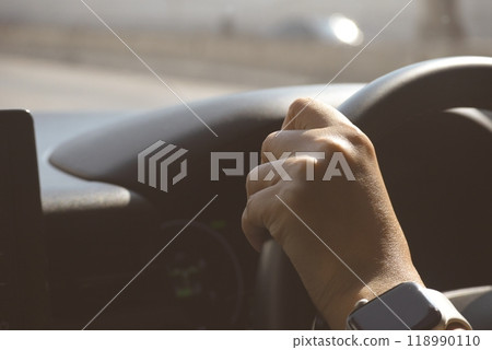 female driver hand hold steering wheel drive vehicle car rode trip travel 118990110
