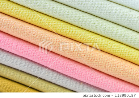 stack of colourful cotton clothes, close up pile of clothing 118990187