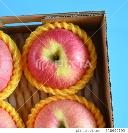 beautiful pink apple in the box on blue background 118990193