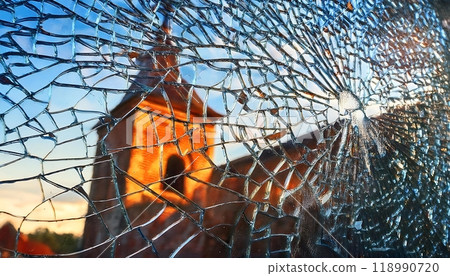 Close-up of broken glass with reflection at the old church wall Close-up of broken glass with reflection at the old church wall 118990720