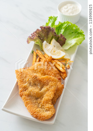 fish and chips - fried fish fillet with potatoes chips fish and chips - fried fish fillet with potatoes chips 118990925