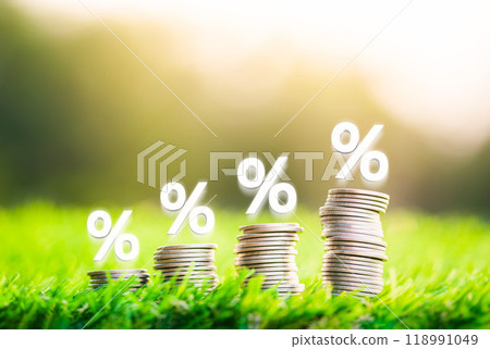 Place the silver coin with the up arrow and the percentage symbol on the wooden block. The concept of interest rates and dividends. Place the silver coin with the up arrow and the percentage symbol on the wooden block. The concept of interest rates and dividends. 118991049