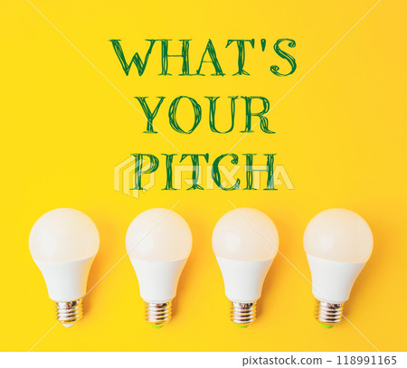 Four white light bulbs arranged in a row on a yellow background Four white light bulbs arranged in a row on a yellow background 118991165