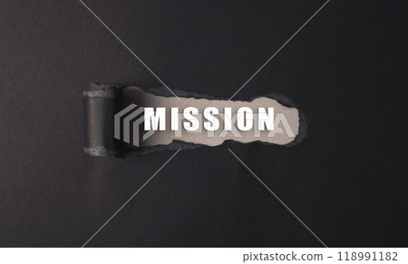 A black and white image of a hole in a piece of paper with the word Mission 118991182