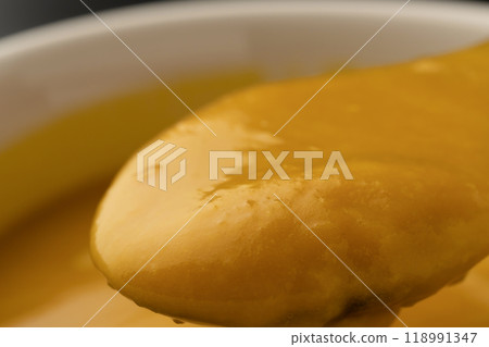 Pumpkin potage: Lifting the potage with a spoon Pumpkin potage: Lifting the potage with a spoon 118991347