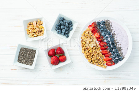 Healthy breakfast . Yogurt with berries ( strawberry , raspberry , blueberry , blackberry ) , granola and chia seeds . Top view Healthy breakfast . Yogurt with berries ( strawberry , raspberry , blueberry , blackberry ) , granola and chia seeds . Top view 118992349
