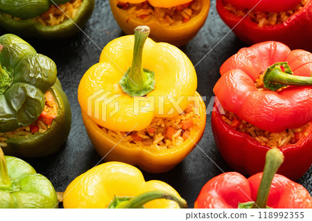 Baked stuffed pepper ( paprika ) with rice , carrot and meat . Top view on rustic background 118992355