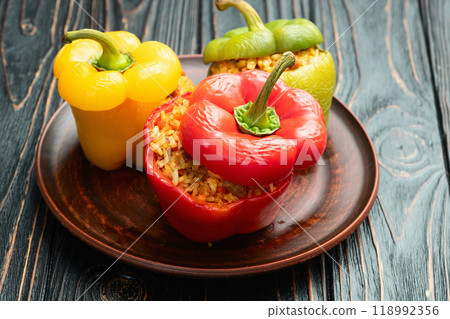 Baked stuffed pepper ( paprika ) with rice , carrot and meat . Top view on rustic background 118992356