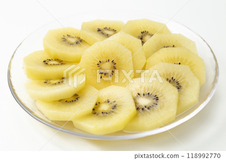 Sliced gold kiwi on a white background 118992770