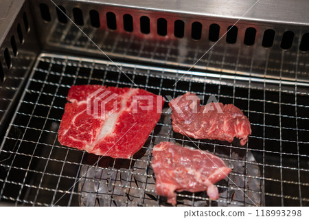 Korean Style Barbecue on stainless grill. BBQ rare meat with soft focus 118993298