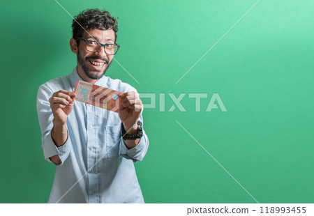 Happy person showing you a single bill. Friendly man with a smile showing one money bill isolated, Concept of person showing a 500 Nicaraguan cordobas bill. Happy person showing you a single bill. Friendly man with a smile showing one money bill isolated, Concept of person showing a 500 Nicaraguan cordobas bill. 118993455
