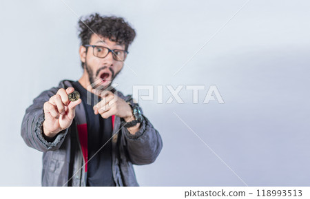 Surprised man holding bitcoin coin, Handsome man pointing bitcoin coin, Person holding bitcoin coin isolated Surprised man holding bitcoin coin, Handsome man pointing bitcoin coin, Person holding bitcoin coin isolated 118993513