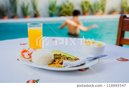 Traditional breakfast served poolside. Traditional morning breakfast near the swimming pool 118993547