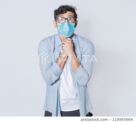 Latin man begging with medical protective face mask. pleading man concept isolated, man asking for a favor 118993669