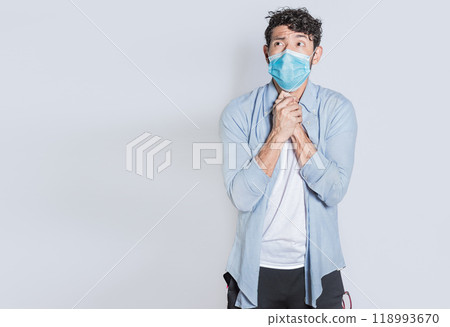 Person with medical mask with hands together begging for a favor or miracle isolated. A young man wearing surgical mask begging for a miracle isolated, man in medical mask asking for a favor Person with medical mask with hands together begging for a favor or miracle isolated. A young man wearing surgical mask begging for a miracle isolated, man in medical mask asking for a favor 118993670