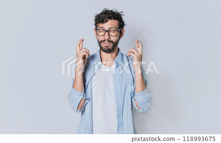 Happy man making a wish, latin guy crossing his fingers making a wish Happy man making a wish, latin guy crossing his fingers making a wish 118993675