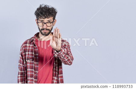 Portrait of handsome man making stop gesture with his palm. Serious man making stop sign with his palm. concept of person doing stop on isolated white background Portrait of handsome man making stop gesture with his palm. Serious man making stop sign with his palm. concept of person doing stop on isolated white background 118993733