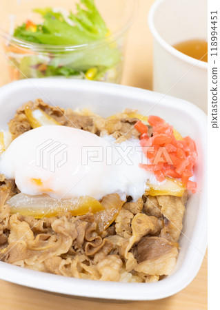 Delicious beef bowl bento with soft-boiled egg and pickled ginger, miso soup and salad 118994451