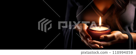 Female Hands Holding a Bright Votive Candle on a Black Background - Generative Ai Female Hands Holding a Bright Votive Candle on a Black Background - Generative Ai 118994859