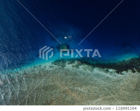 Seascape aerial drone view over reef with boats in Bali Seascape aerial drone view over reef with boats in Bali 118995104