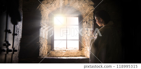 Young girl at old window 118995315
