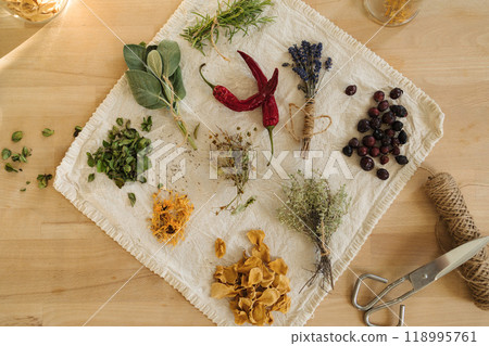 Top view of dried herbs and seasonings on linen tablecloth. Healthy homemade and natural. Top view of dried herbs and seasonings on linen tablecloth. Healthy homemade and natural. 118995761