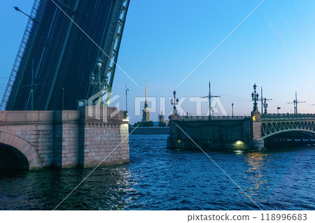 raised Liteyny Bridge in St. Petersburg on a white night, the Peter and Paul Cathedral is visible in the background raised Liteyny Bridge in St. Petersburg on a white night, the Peter and Paul Cathedral is visible in the background 118996683
