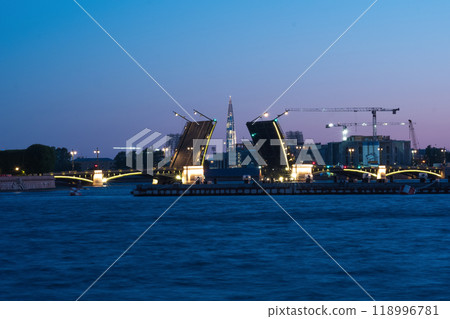 raised bascule Palace Bridge in St. Petersburg on a white night, the Lakhta Center skyscraper is visible in the background 118996781